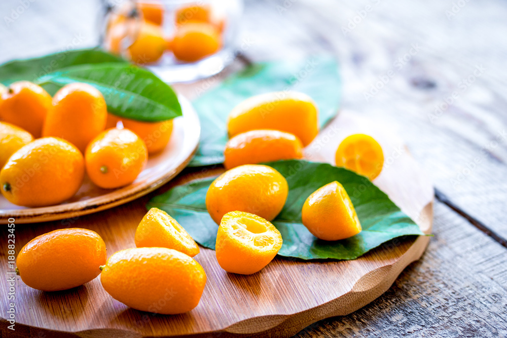 kumquat on plate at wooden table