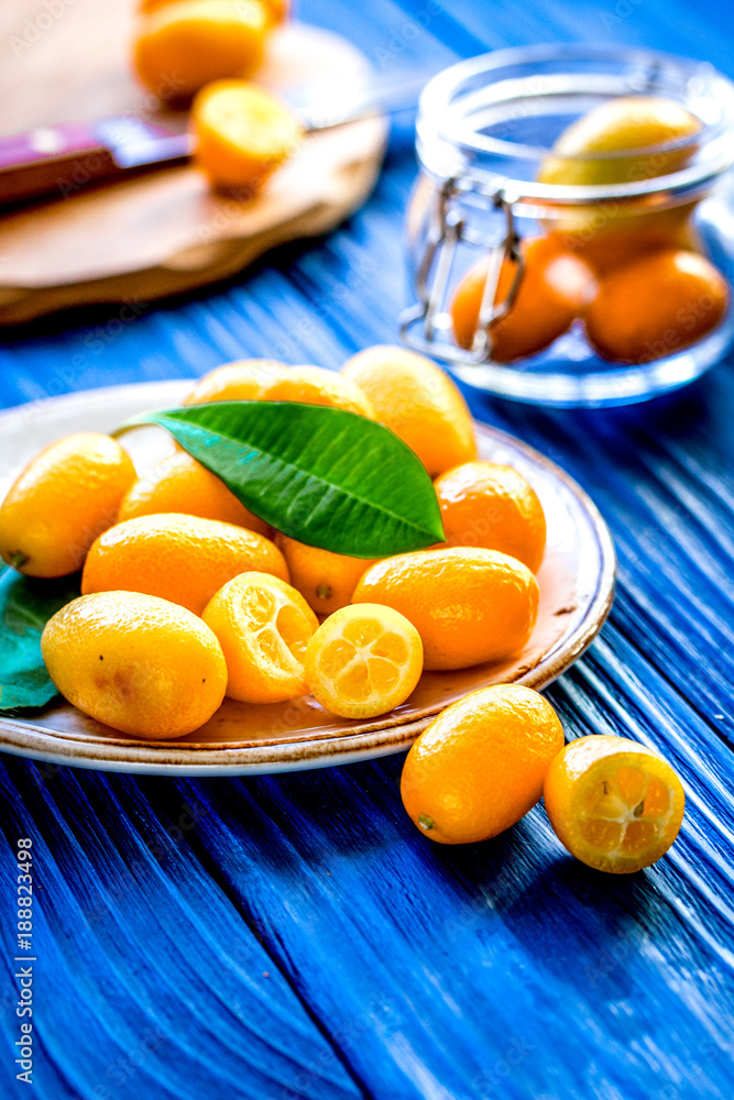 kumquat on plate at wooden table