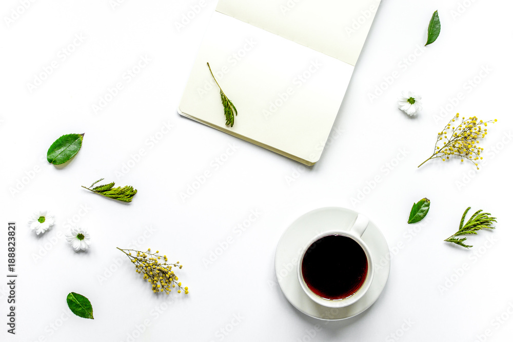 Notebook with cup of coffee on white background top view mockup