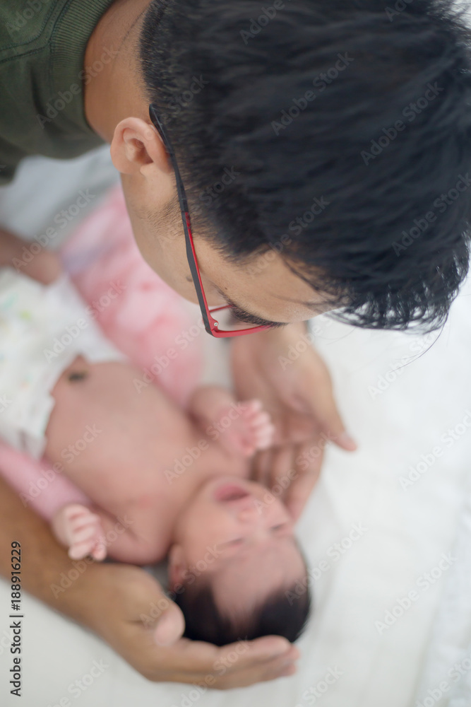 Asian father take care his adorable newborn baby carefully