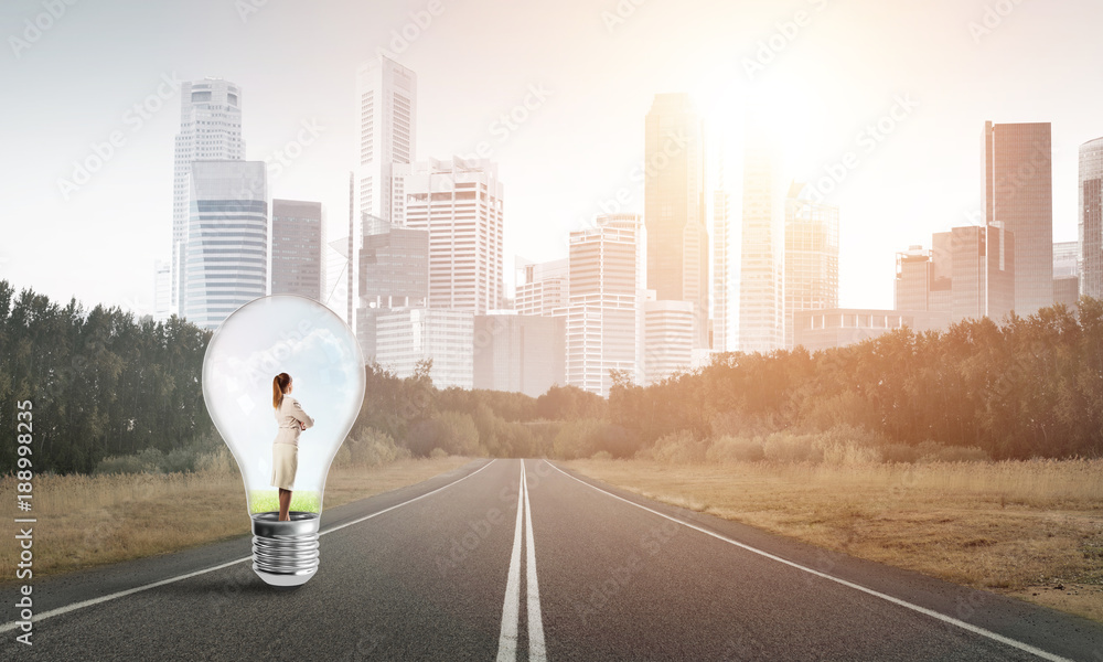 Businesswoman inside light bulb