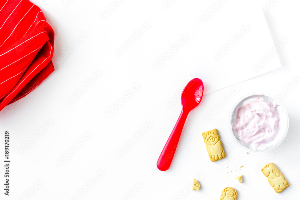 concept kid breakfast with yogurt top view white background