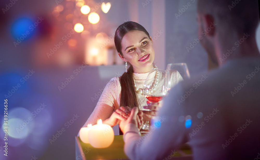 Romantic dinner. Young couple toasting wine glass in restaurant. Dating