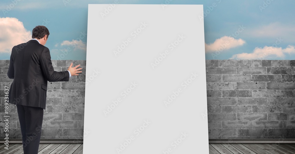 Businessman standing by white board