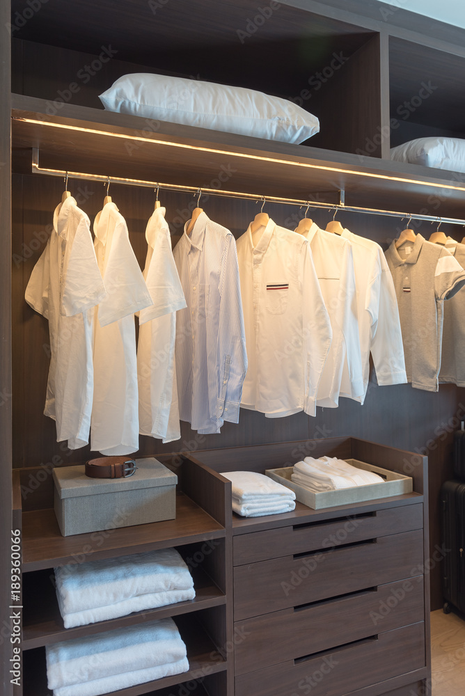 row of white shirts on rail