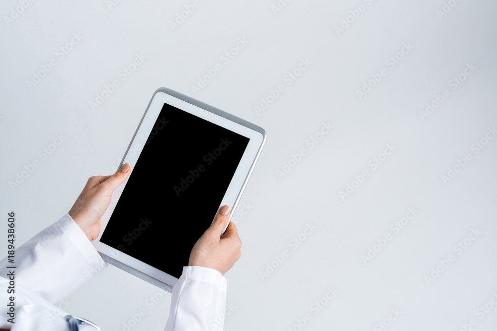 Close of female doctor hands working with tablet pc computer