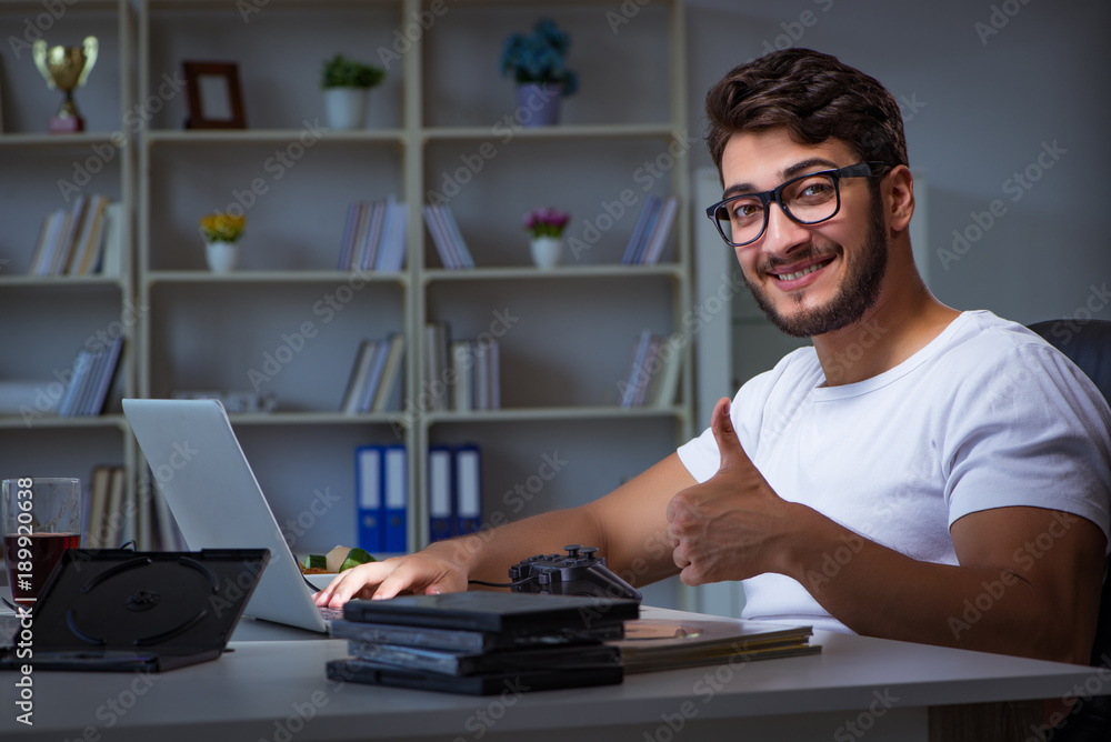 Young man staying late in office to do overtime work