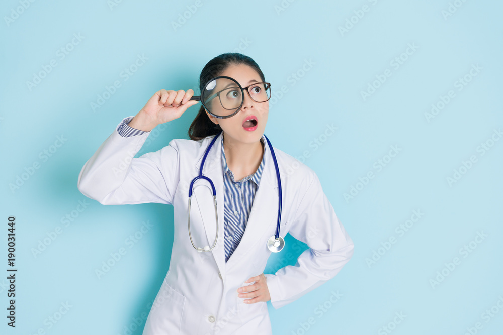 beautiful pretty doctor woman holding magnifier