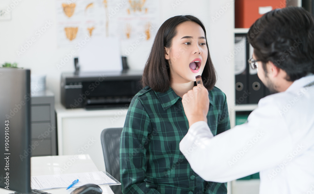 The doctor is examining the mouth, teeth, tongue of the patient.