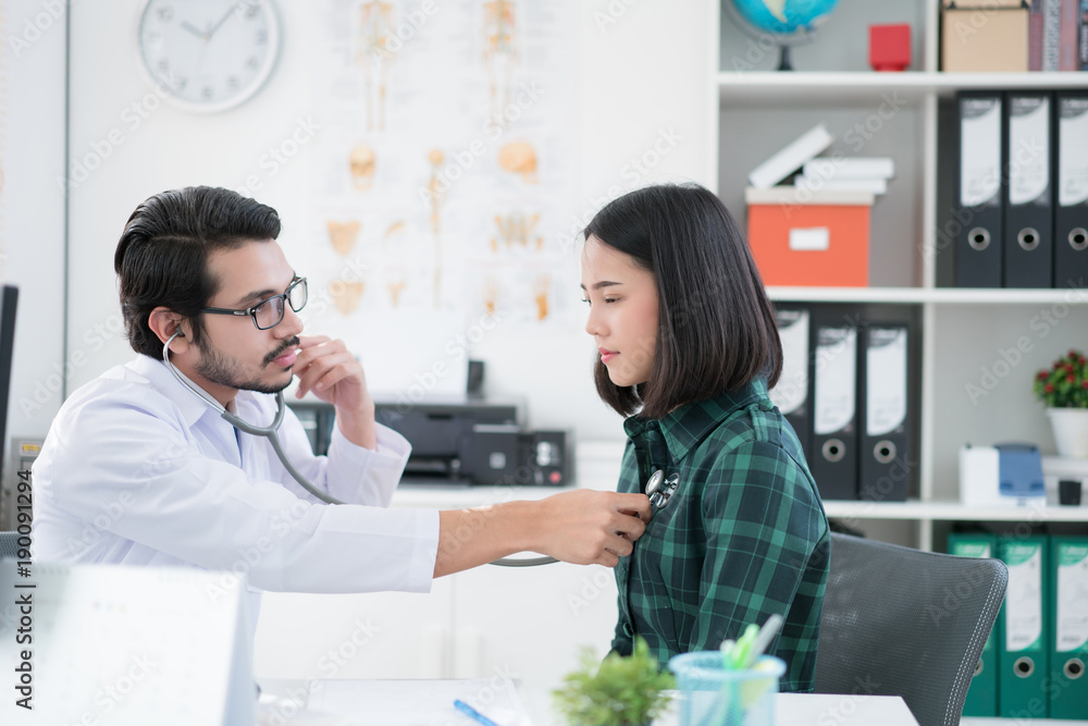 Doctors are using a stethoscope to check lungs and heart.