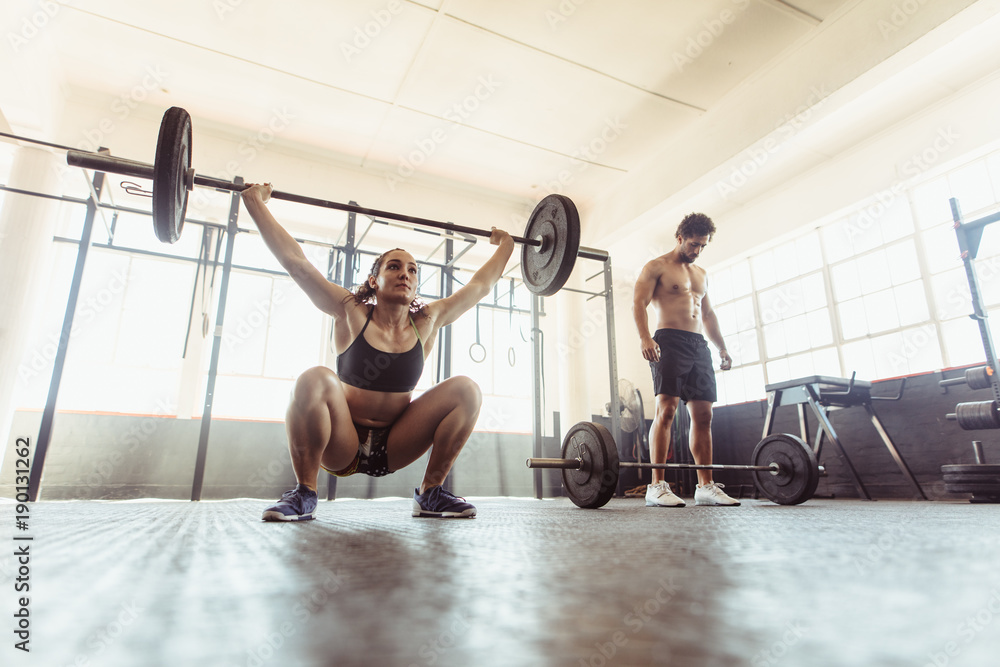 Woman performing deadlift exercise