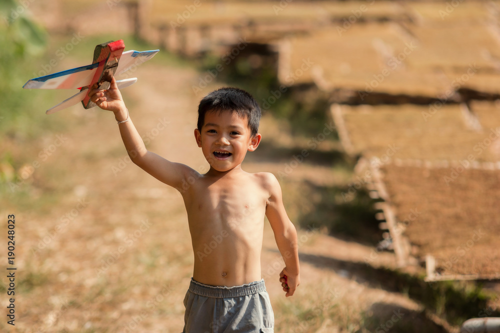 Children playing at the tobacco garden.Tobacco plant in garden of thailand.