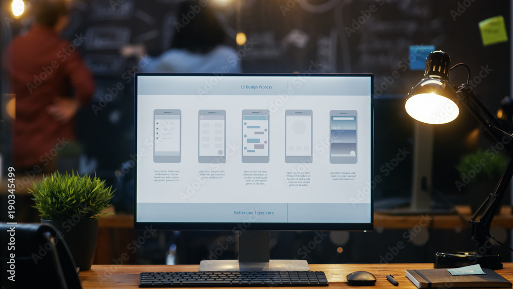 Personal Computer with Mobile Application Design Showing on the Monitor Stands on the Office Desk, I