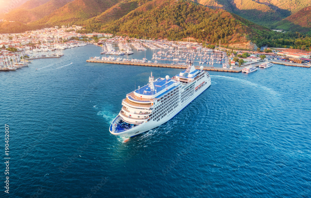 Cruise ship at harbor. Aerial view of beautiful large white ship at sunset. Colorful landscape with 