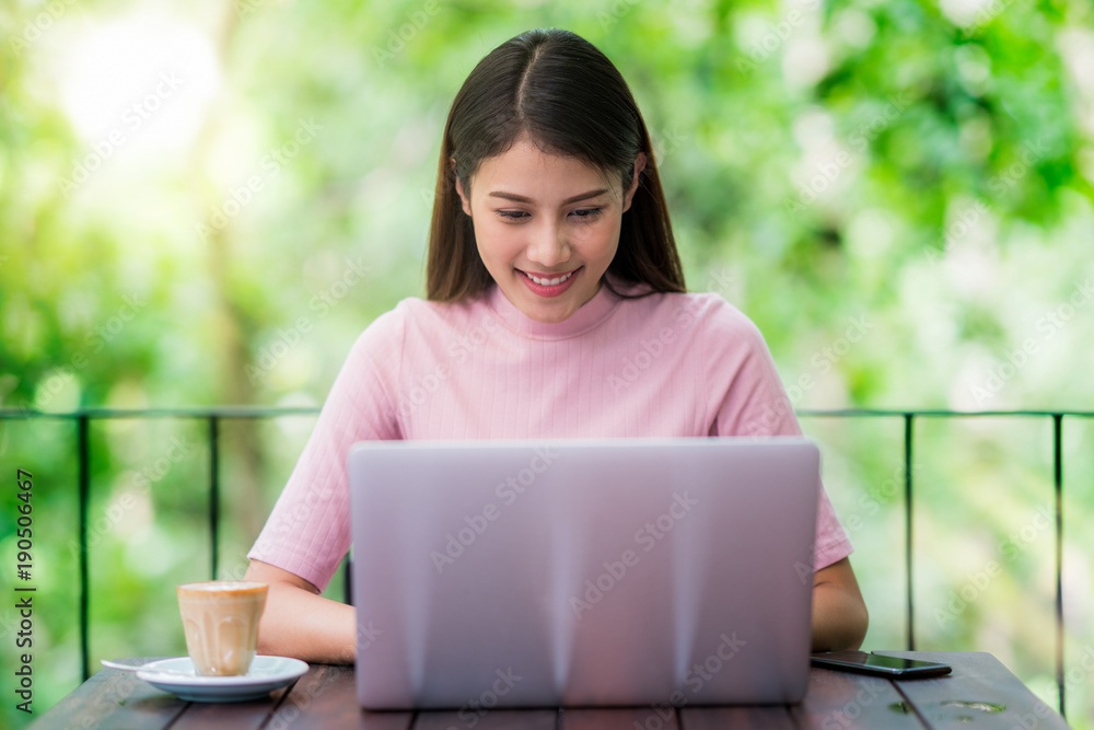 Asian lady working with computer note book and drink a coffee