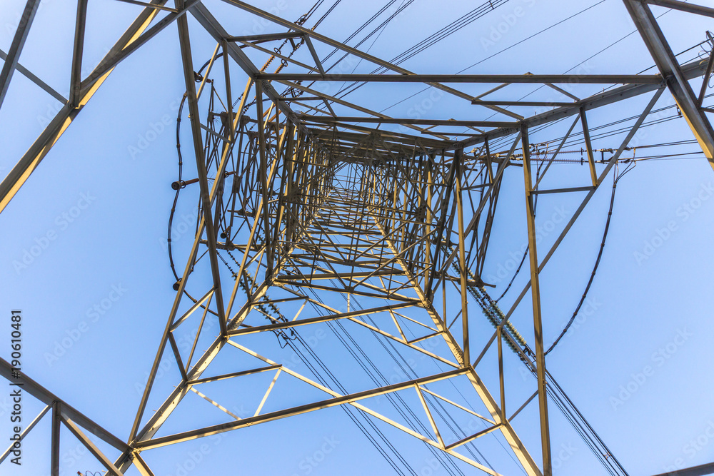 metal telegraph posts with blue sky