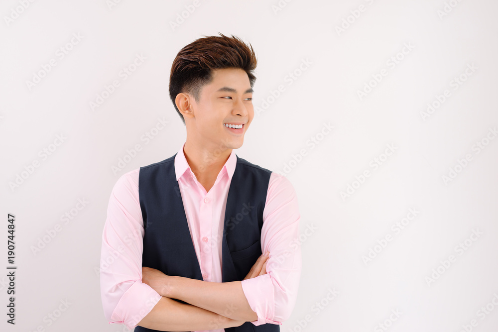 Handsome asian man stand and smile posing on gray background