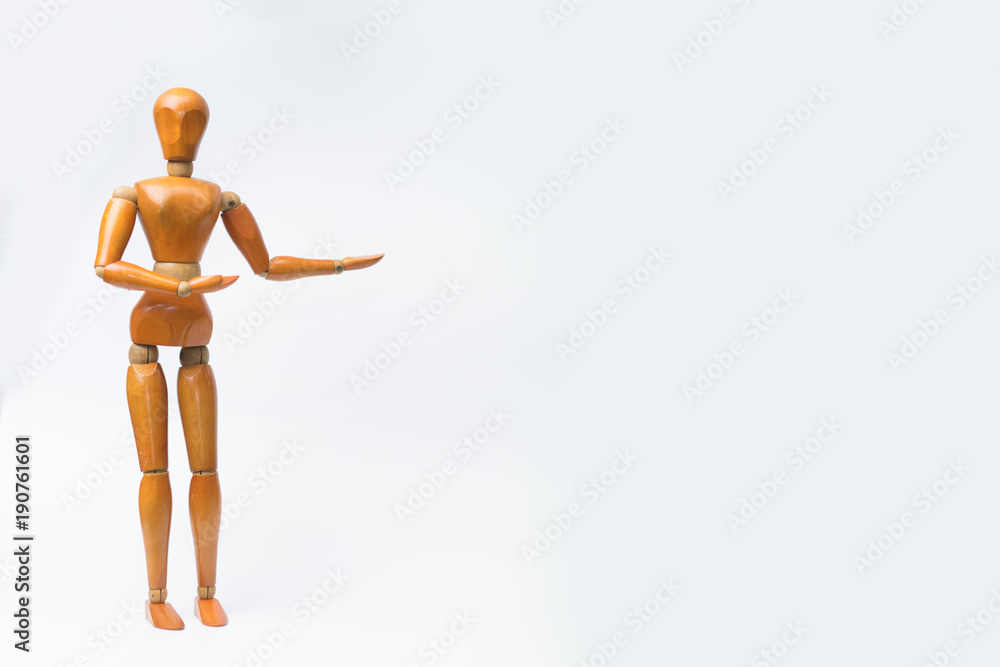 Wooden figure pose raising arm hand to introduce product for business.white isolated background