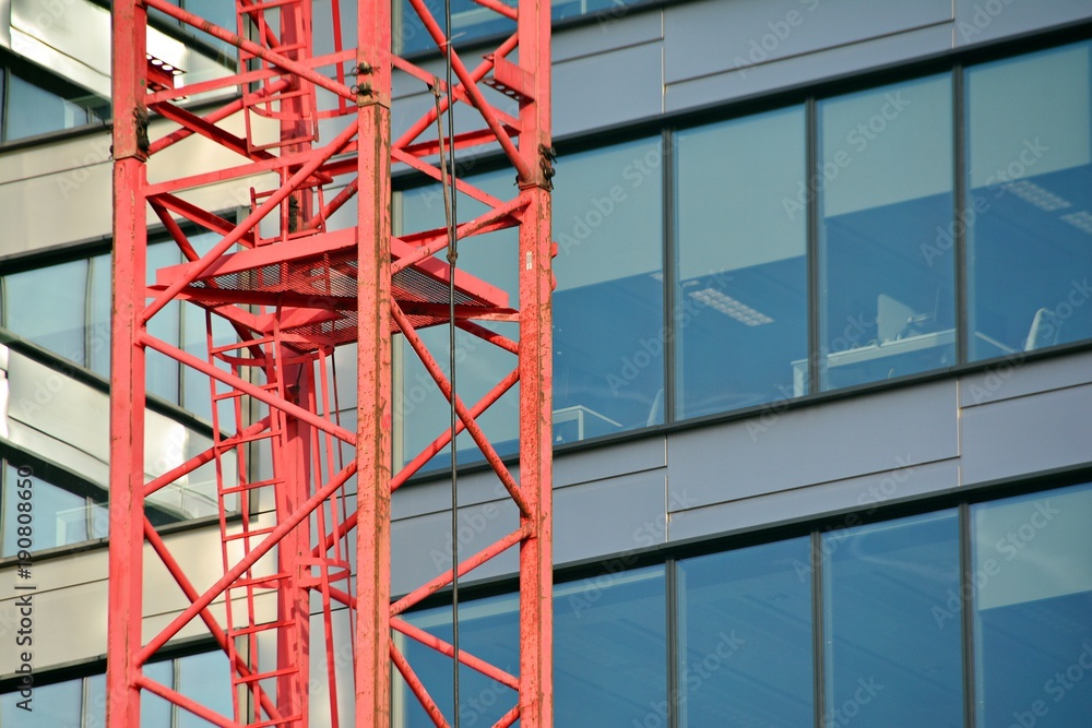 Construction of high-rise office center with modern technology. Fragment of a building on a light ba