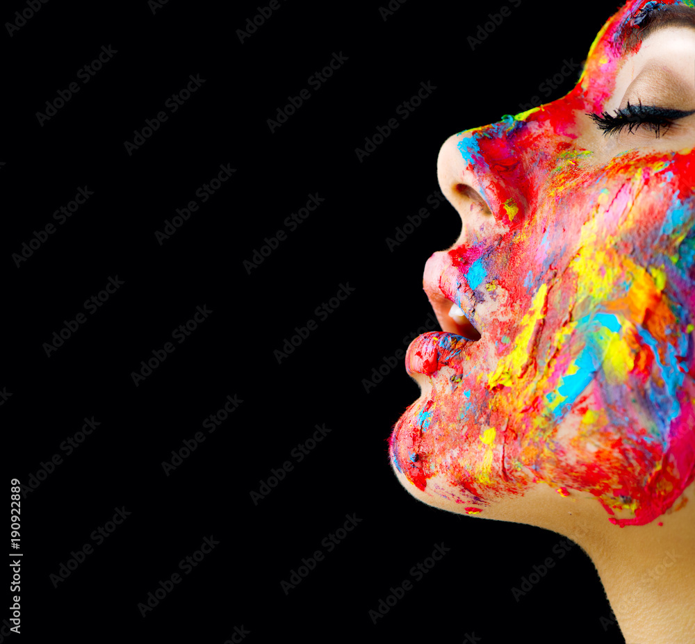 Beauty model girl with colorful paint on her face. Portrait of beautiful woman with flowing liquid p