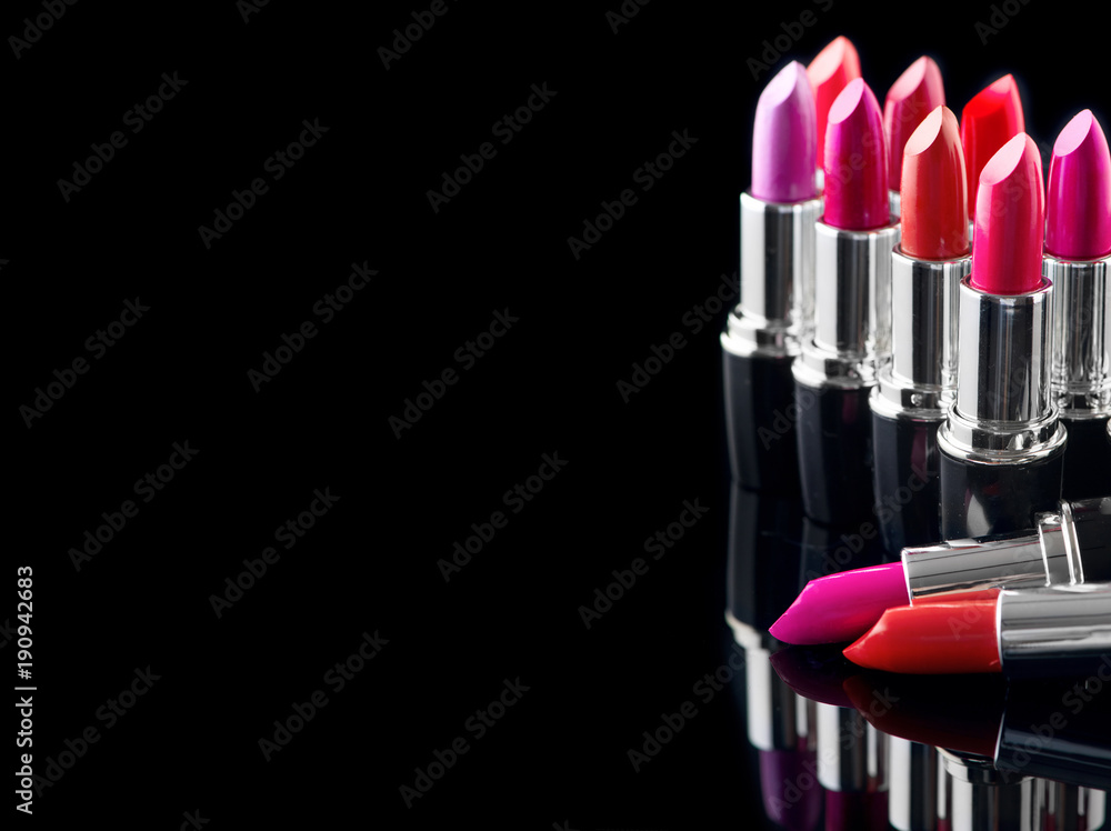 Lipstick. Professional makeup and beauty. Lipstick tints palette closeup. Colorful lipsticks over bl