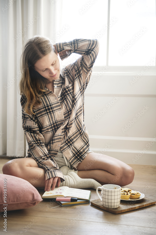 Caucasian girl sitting on the wooden floor