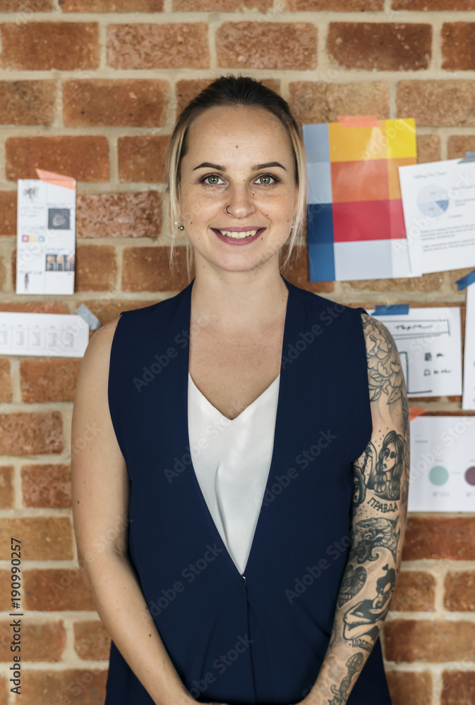 Portrait of Caucasian woman against brick wall