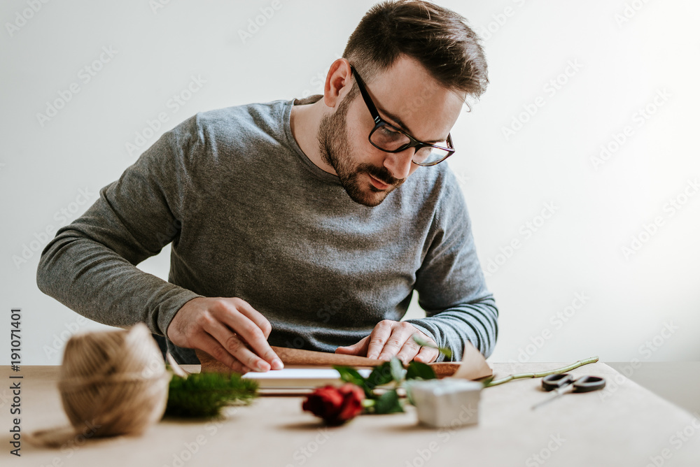 Man wraps present for Womens day.