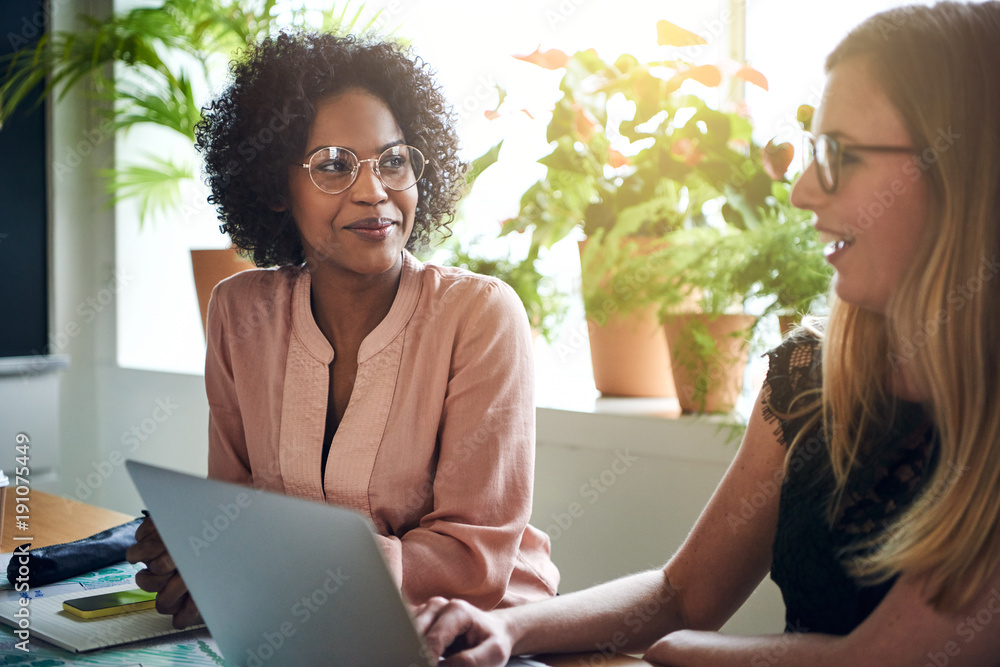 Businesswomen working together at a boardroom table in an office