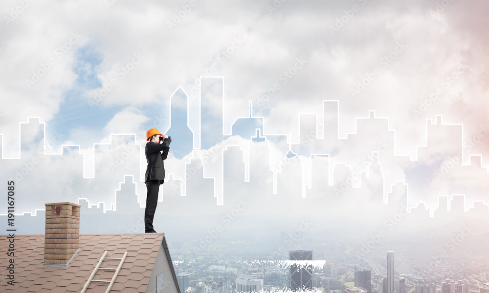 Engineer man standing on roof and looking in binoculars. Mixed media