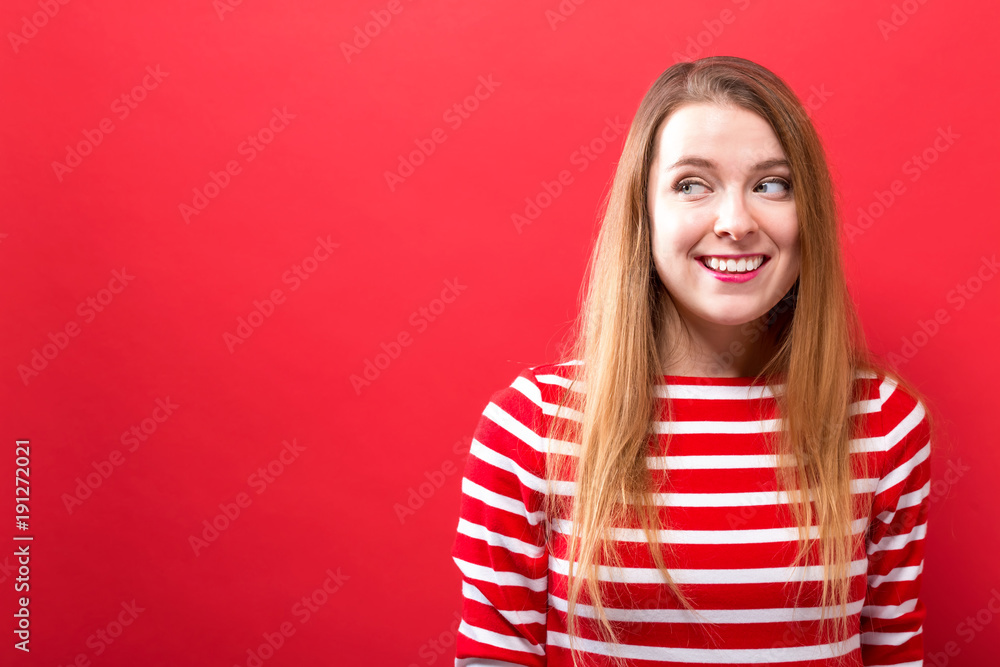 Young woman thinking on a solid background