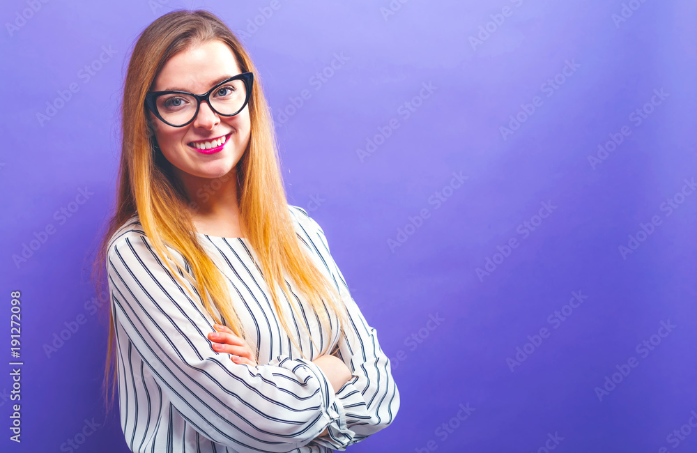 Happy young woman on a solid background