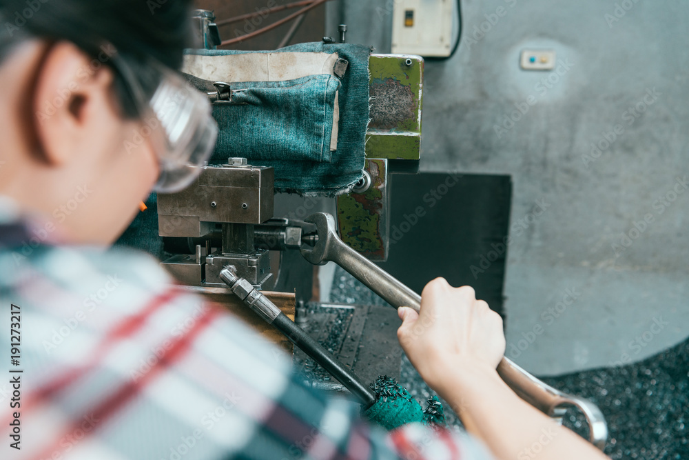 back view of factory worker wearing safety goggles