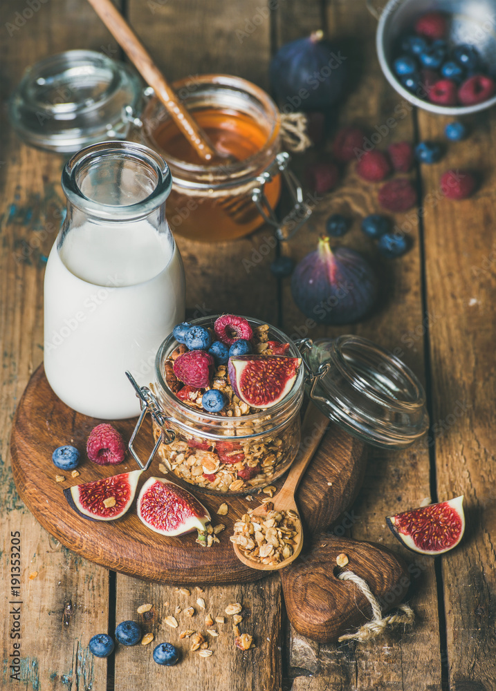 Healthy vegan breakfast. Oatmeal granola with bottled almond milk, honey, fresh fruit and berries on