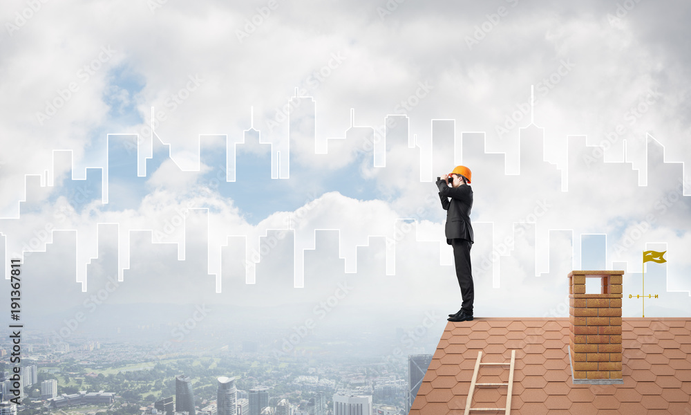 Engineer man standing on roof and looking in binoculars. Mixed media