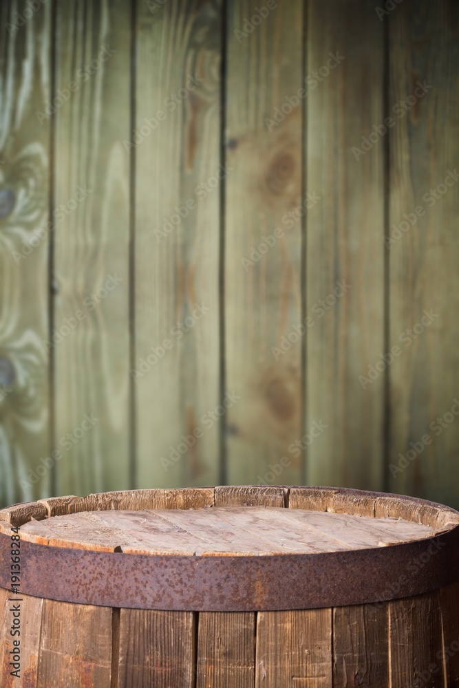 Old wooden barrel on a wooden background