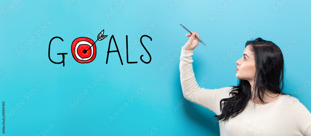 Goals with young woman holding a pen on a blue background