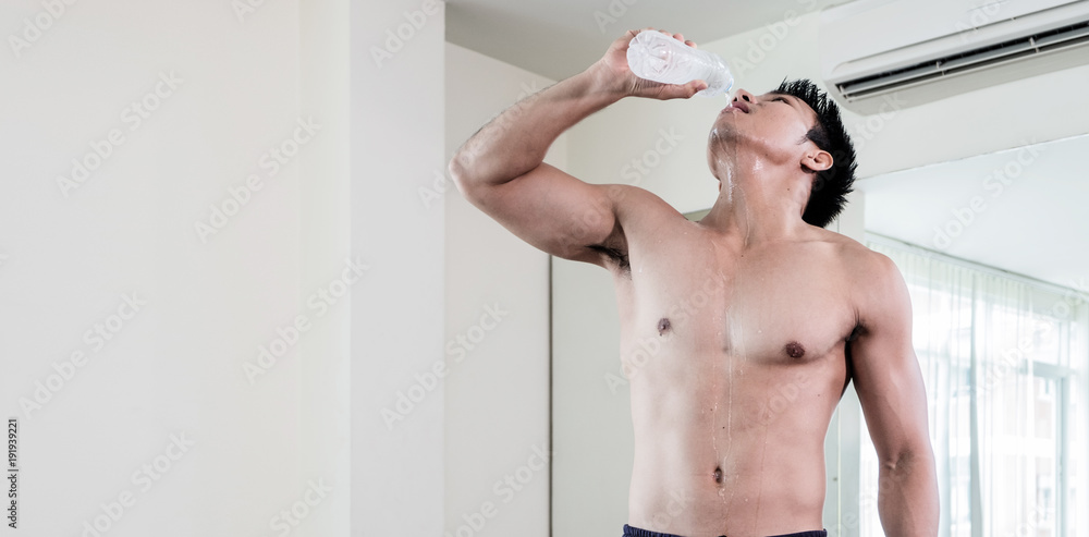 asian body builder is realx with drink pure water healthy ideas concept