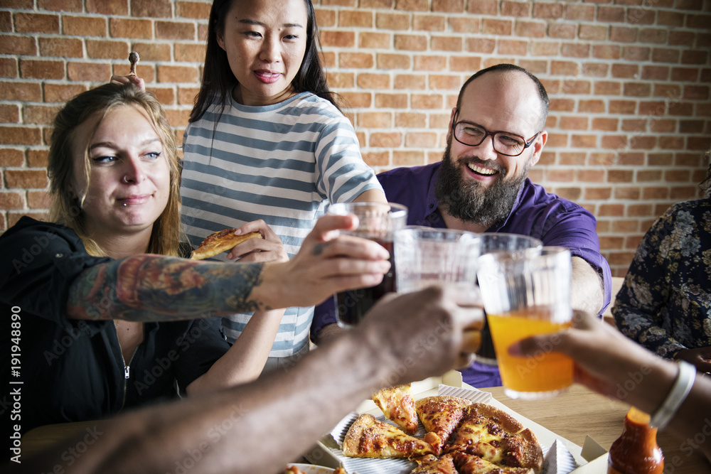 Friends eating pizza together at home