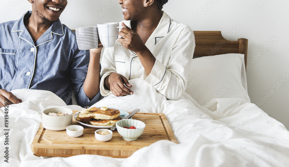 A couple having breakfast in bed