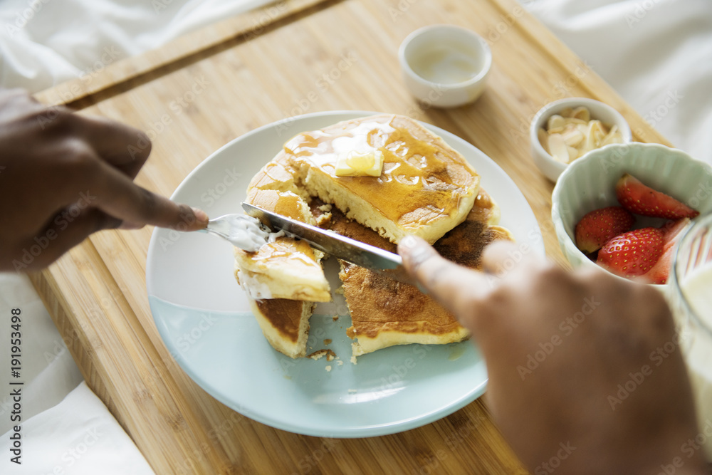 A person having breakfast in bed