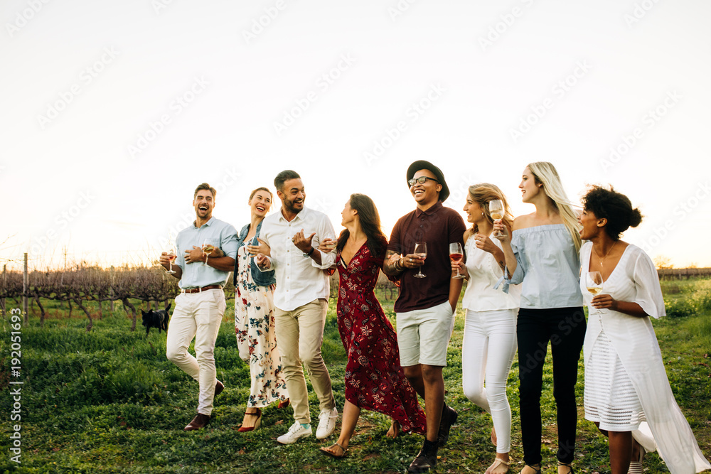 Group of friends chilling outside at vineyard