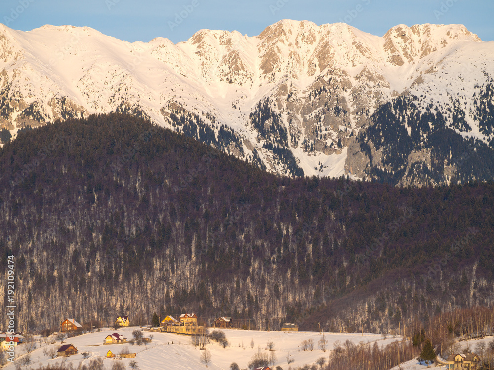 Winter rural scene in the mountains. Carpathians mountains, Romania. Countryside landscape in Transy