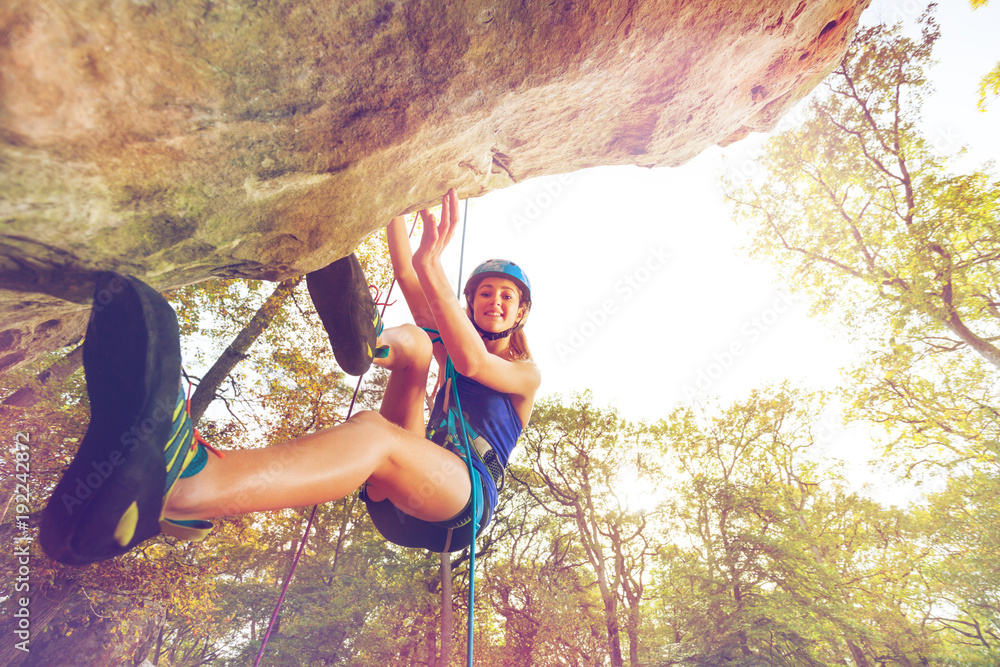 Rock climber training outdoors at sunny day