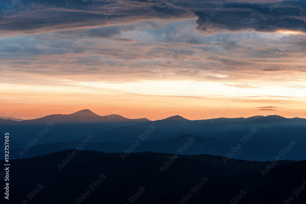 Picturesque summer landscape with colorful sunrise on Carpathian mountains. Mountain ranges in morni