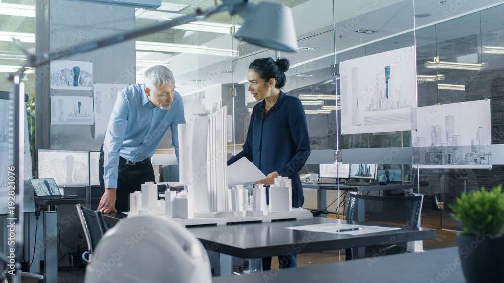 In the Architectural Bureau Two Engineers Work on a Model of a City District. Urban Planners Work on