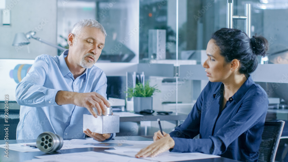 Experienced Male and Female Industrial Engineers have Discussion, Making Adjustment and Perfecting P