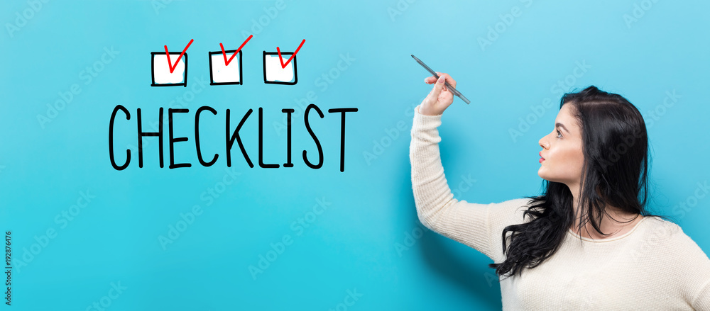 Checklist with young woman holding a pen on a blue background