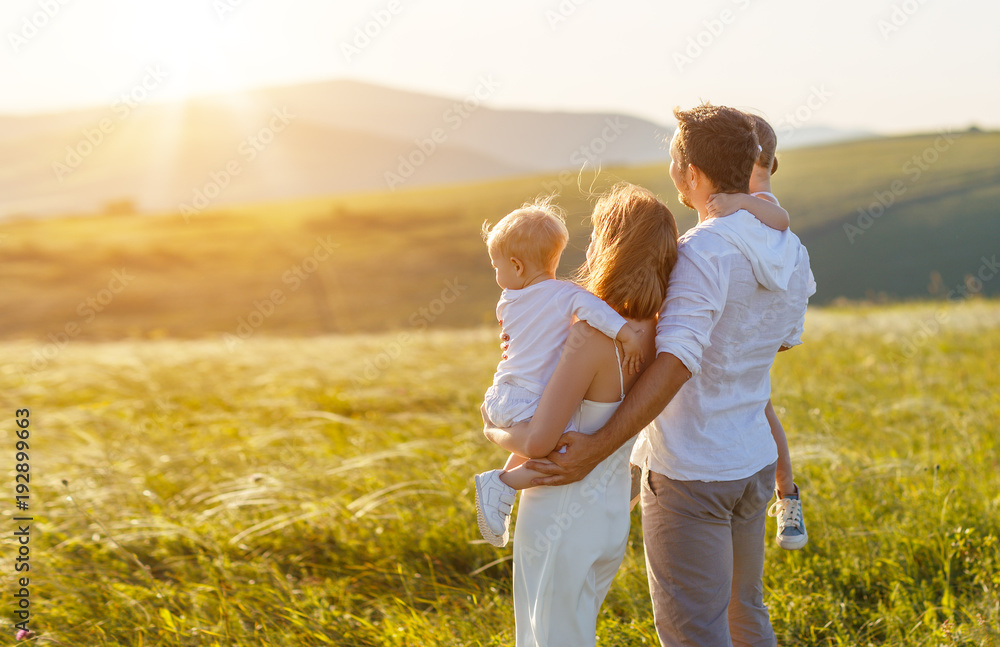 fathers day. child daughter sits on her dad shoulders outdoors on a summer