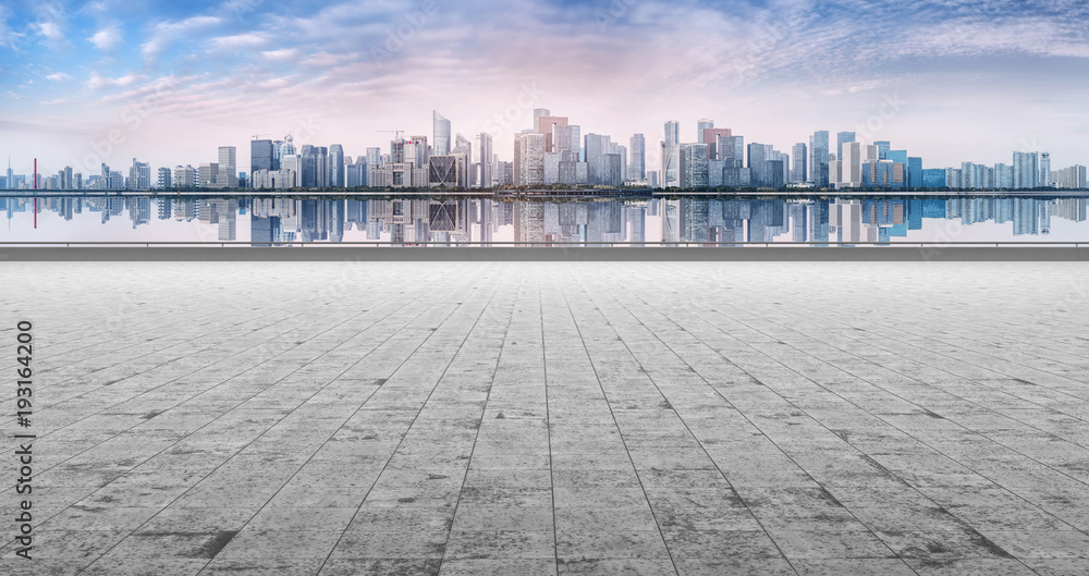 View of the skyline of Hangzhou urban architectural landscape from square floor tiles and empty asph